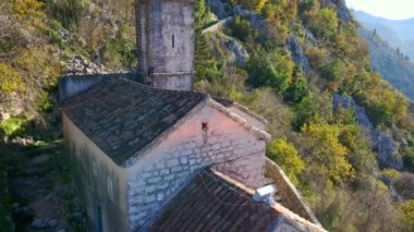 Aerial shot of the Christian church on a way to the top of the mountain where st. Johns fort is located. Crkva Gospe od Zdravlja, church of St. Mary of Health in Kotor. Travel to Montenegro concept.