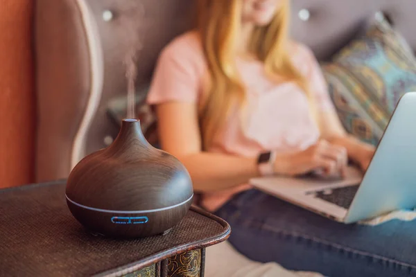Woman Sits Bed Works Laptop Aroma Diffuser Next Bed — Stock Photo, Image