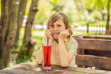 Portrait of a disgruntled girl sitting at a cafe table.