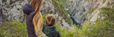 BANNER, LONG FORMAT Mom and son tourists in the background of Beautiful Canyon of Moraca river in winter, Montenegro or Crna Gora, Balkan, Europe.