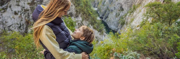 BANNER, LONG FORMAT Mom and son tourists in the background of Beautiful Canyon of Moraca river in winter, Montenegro or Crna Gora, Balkan, Europe.