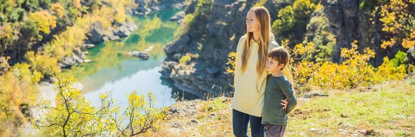 BANNER, LONG FORMAT Montenegro. Mom and son tourists on the background of Clean clear turquoise water of river Moraca in green moraca canyon nature landscape. Travel around Montenegro concept.