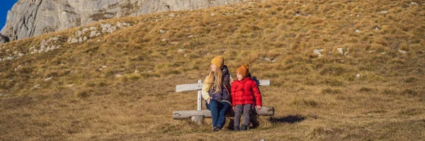 BANNER, LONG FORMAT Montenegro. Mom and son tourists in the background of Durmitor National Park. Saddle Pass. Alpine meadows. Mountain landscape. Travel around Montenegro concept.