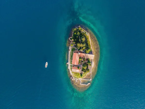 Aerophotography. View from flying drone. St George Island in the Bay of Kotor at Perast in Montenegro, with St George Benedictine Monastery. St. George Island, is a small natural island off the coast.