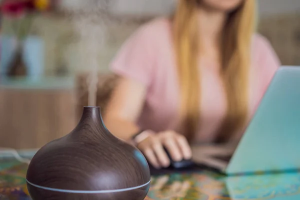 Essential Oil Diffuser Table Steaming While Woman Using Laptop — Stock Fotó