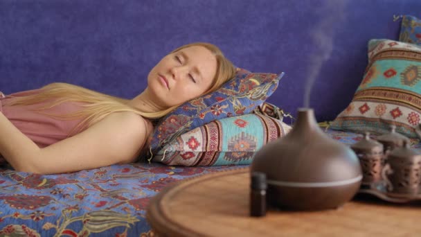 Young Woman Enjoys Atmosphere Created Aroma Diffusor She Laying Couch — Stock videók