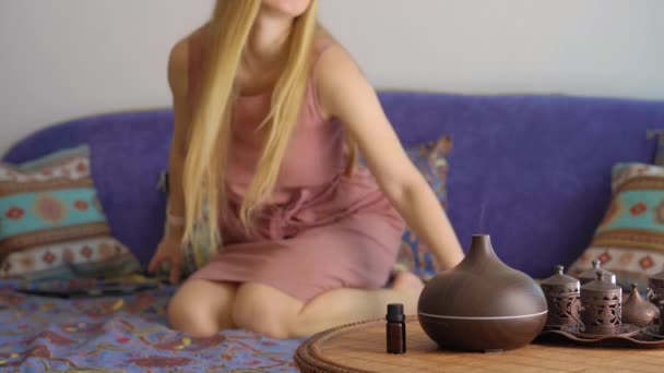Young Woman Turns Aroma Lamp Enjoys Atmosphere Creates She Sitting — стоковое видео