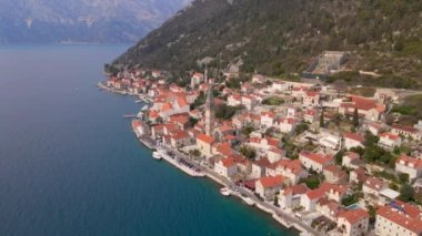 Hava videosu. Perast şehrinin manzarası. Şehrin merkezinde Saint Nikolas kilisesinin çan kulesi bulunmaktadır. Karadağ 'a Seyahat.