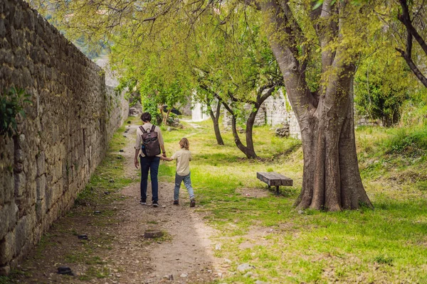 Dad and son tourists walks through the old town of Bar in Montenegro. Happy tourist walks in the mountains. Suburbs of the city of Bar, Montenegro, Balkans. Beautiful nature and landscape.