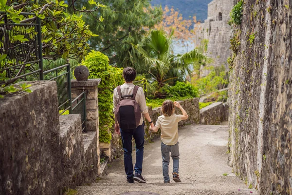 Father and son tourists in Herceg Novi old town. Historical and touristic center of Herceg Novi. Montenegro.