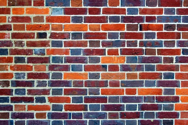 Tuğla duvarı kapat, kırmızı, turuncu, mavi tuğla kalıbı.