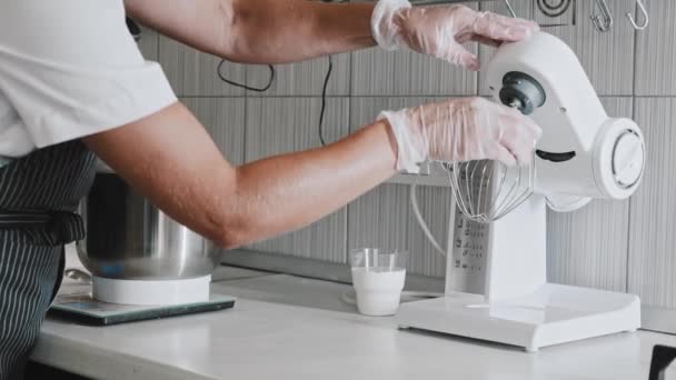 Woman chef making dough - putting a bowl under the blender — Stock Video