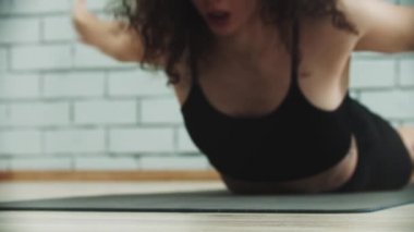 Sırtı için egzersiz yapan genç bir kadın.