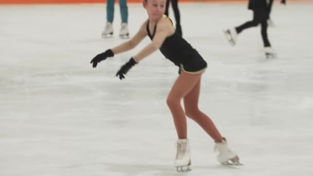 Petite fille patineuse artistique à l'entraînement costume de patinage et de tourner autour sur la patinoire — Video