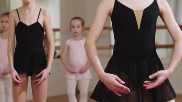 Treinamento de balé - pequenas garotas bailarinas se agachando no estúdio — Vídeo de Stock