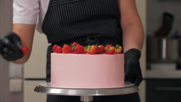 Rózsaszín torta díszítése friss eperdarabokkal — Stock videók