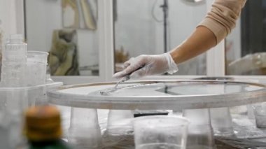 Epoksi tasarım - bir spatula kullanarak yuvarlak resme gri epoksi reçine sürmek