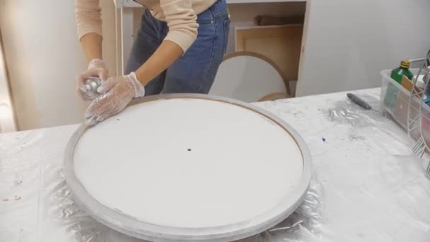Pulverización de pintura plateada sobre el marco redondo de madera del lienzo — Vídeos de Stock