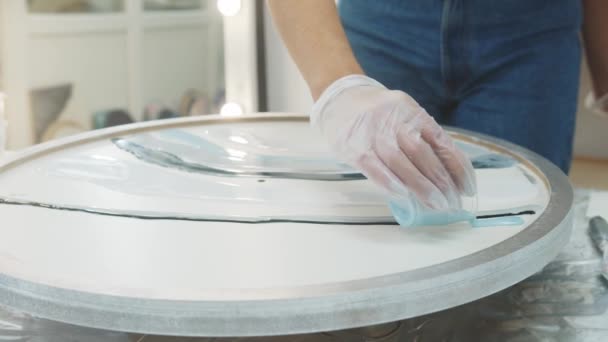 Verter pintura de resina epoxi azul pastel en la superficie redonda — Vídeo de stock