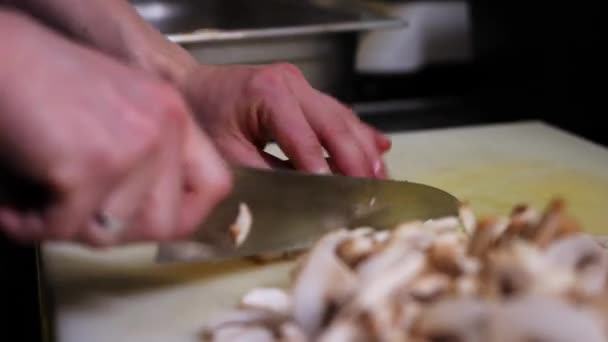 Slicing mushrooms on a cutting board at the restaurant — Stock Video