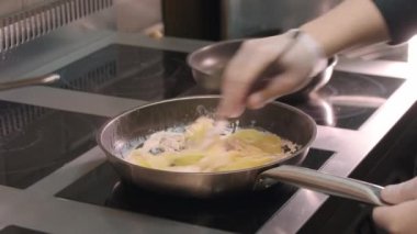 Restoran yemekleri - şef krema ezmesini kızartma tavasında mantarla karıştırıyor