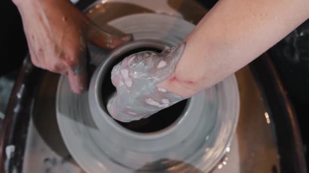 Pottery - a woman thinning the sides on wet clay pot on the wheel — Stock Video