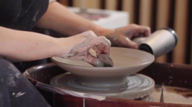 Çömlek tekerindeki kil levhayı saç kurutma makinesiyle ısıtmak ve içerideki kilden fazla kilden kurtulmak.