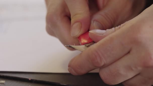 Sharpening a pencil with a box cutter — Video Stock