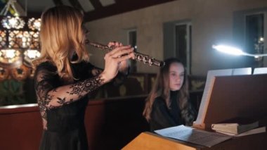 Flutist and organist playing music in church