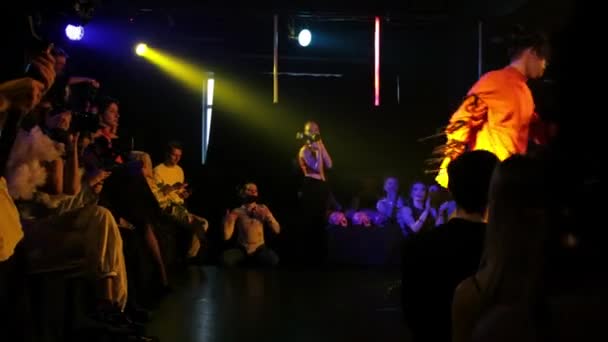RUSSIA, KAZAN 20-02-2022: a modern young man in bright fashionable clothes walks on the stage in a club — Stockvideo
