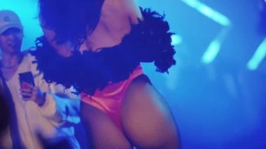 RUSSIA, KAZAN 20-02-2022: a woman with nice ass in mesh tights walks on the podium in the club