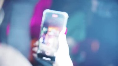 RUSSIA, KAZAN 20-02-2022: a person records a dance show in a nightclub on a phone camera
