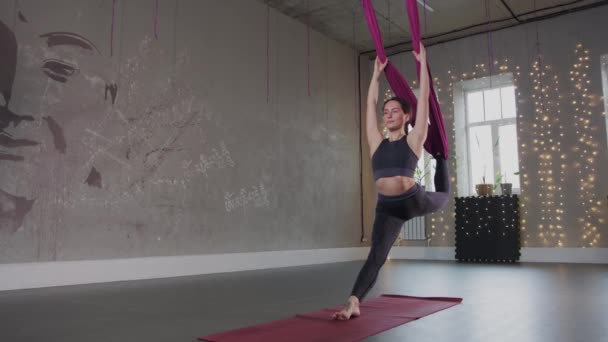 Aerial yoga - young woman having fitness training with a hammock — Stock video