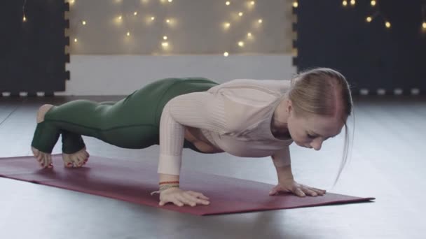Blonde woman does yoga exercises in the studio — Stok Video