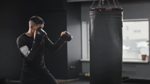 Athletic Young Man Boxer Hitting Punching Bag Mid Shot — Stock Video