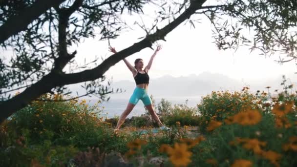 Woman Sportswear Stretching Her Body Hill Sea Mid Shot — Vídeos de Stock