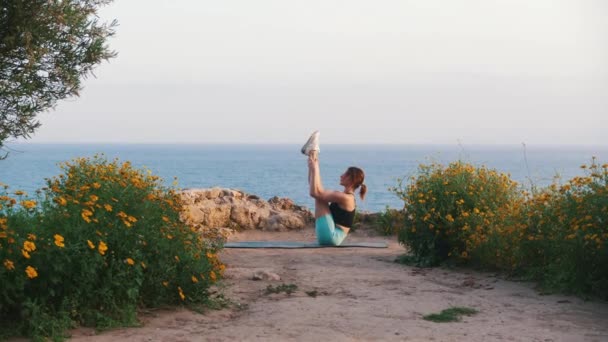Kvinna Sportkläder Gör Stretchövningar Yogamattan Vid Havet Mittskott — Stockvideo