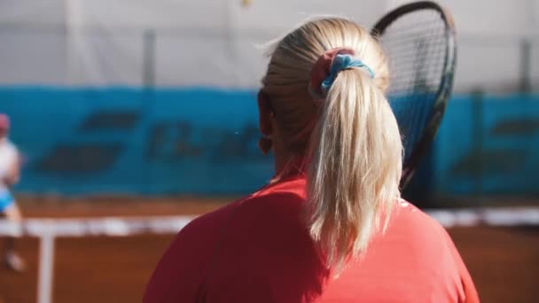 Coach Serves Tennis Balls Two Women Net Court Mid Shot — Video