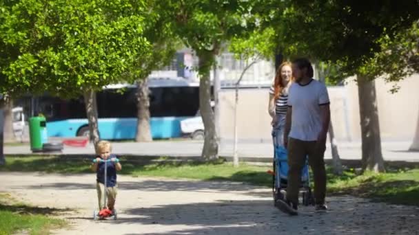 Young Family Walks Sidewalk Mid Shot — Video Stock