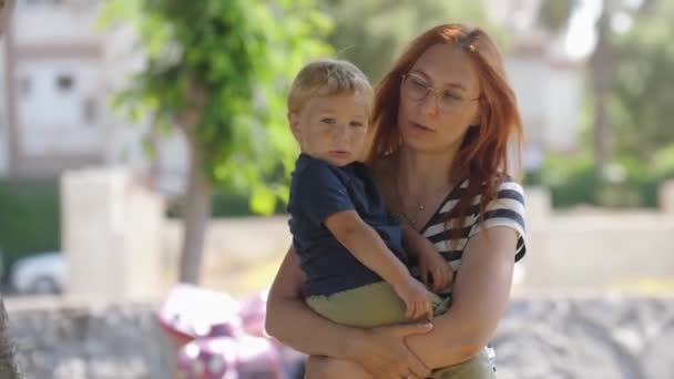 Little Blonde Boy Hands His Red Haired Mother Walking Park — Stock Video