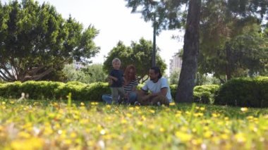 Family in the green park. Mid shot