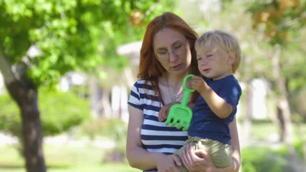 Red Haired Mother Holding Her Son Her Hands Mid Shot — Vídeo de Stock