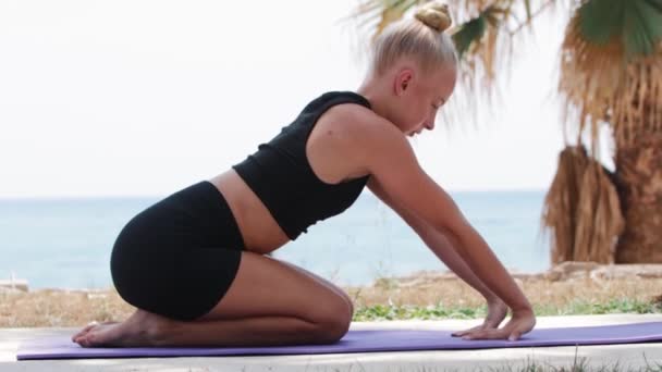 Blonde Young Woman Kneads Her Hands Yoga Mat Nature Mid — Wideo stockowe