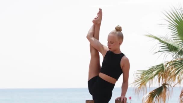 Blonde Gymnastic Woman Stretching Her Body While Leaning Her Hand — Αρχείο Βίντεο
