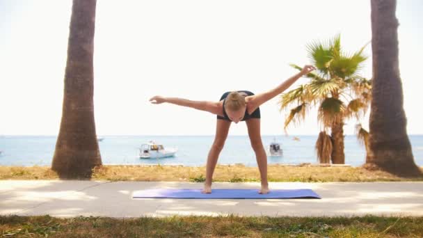 Gymnastics Sea Blonde Woman Warms Her Body Standing Yoga Mat — стоковое видео