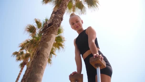 Gymnastics Beach Young Woman Leaning High Beams Looks Camera Smile — Αρχείο Βίντεο