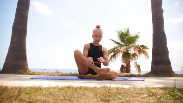 Young Female Gymnast Sits Yoga Mat Puts Wireless Headphones Mid — Stok video