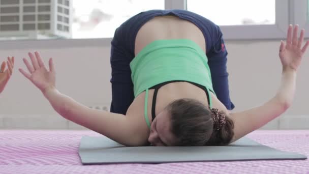 Women Doing Lower Yoga Postures Studio Mid Shot — Stockvideo