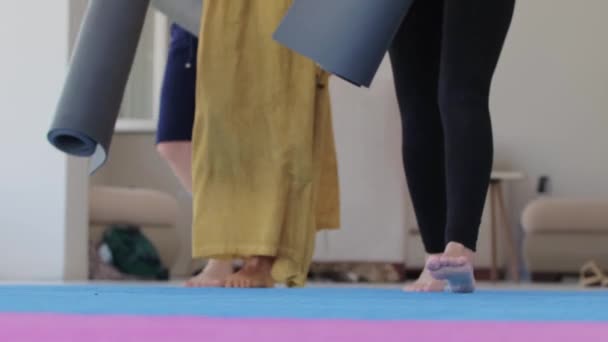 Three Women Walks Studio Puts Yoga Mats Floor Mid Shot — Stok video