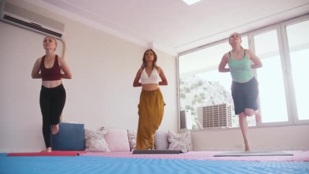Yoga Class Three Women Yoga Mats Balancing One Leg Mid — Stock video
